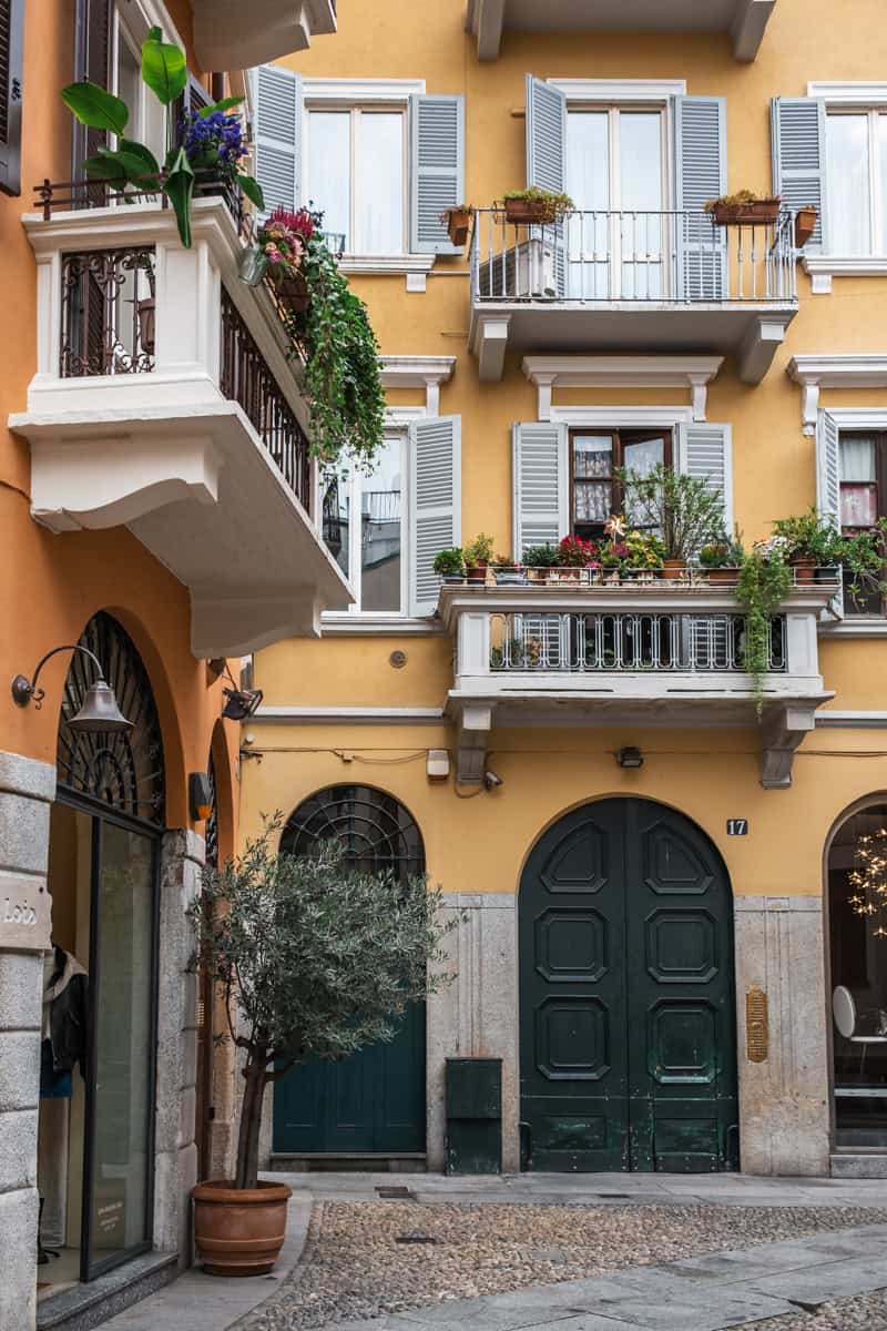 Yellow and orange houses in Brera, Milan, with beautiful plants and balconies