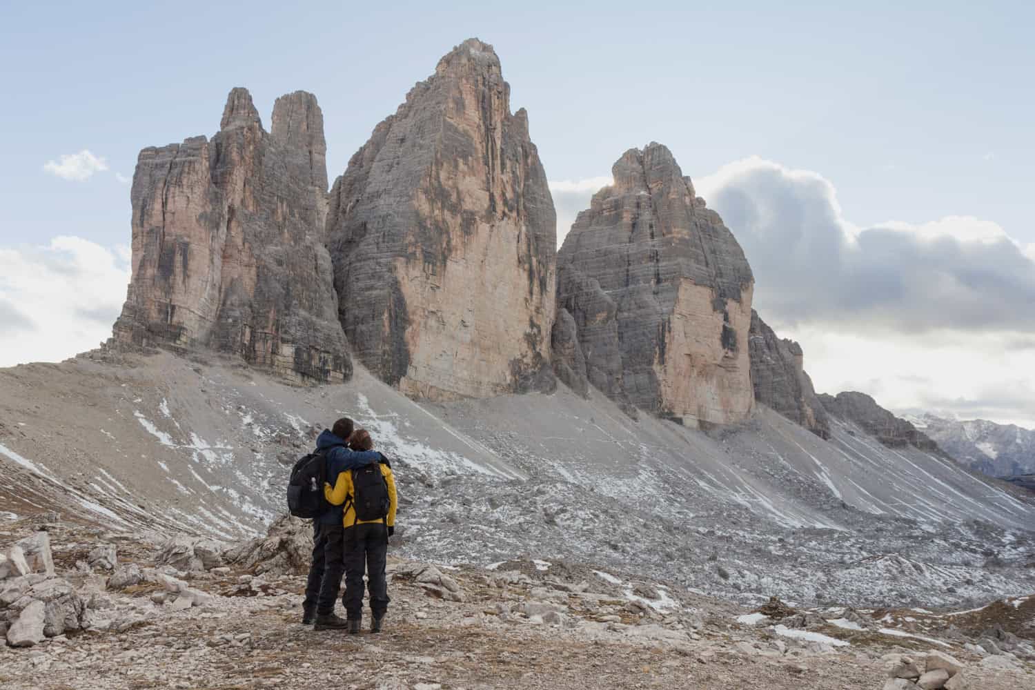 A couple embracing in front of the peaks of Tre Cime di Lavaredo 