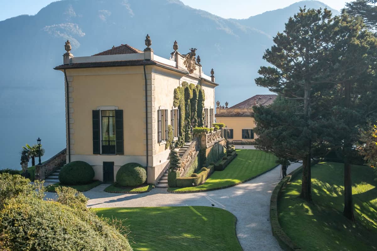 The gardens of Villa del Balbianello, with manicured lawns, statues and incredible lake views