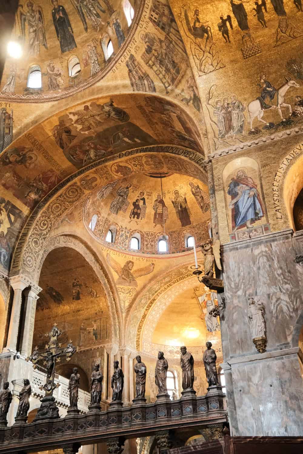 Glowing golden mosaics covering the ceilings and arches inside St. Mark’s Basilica.