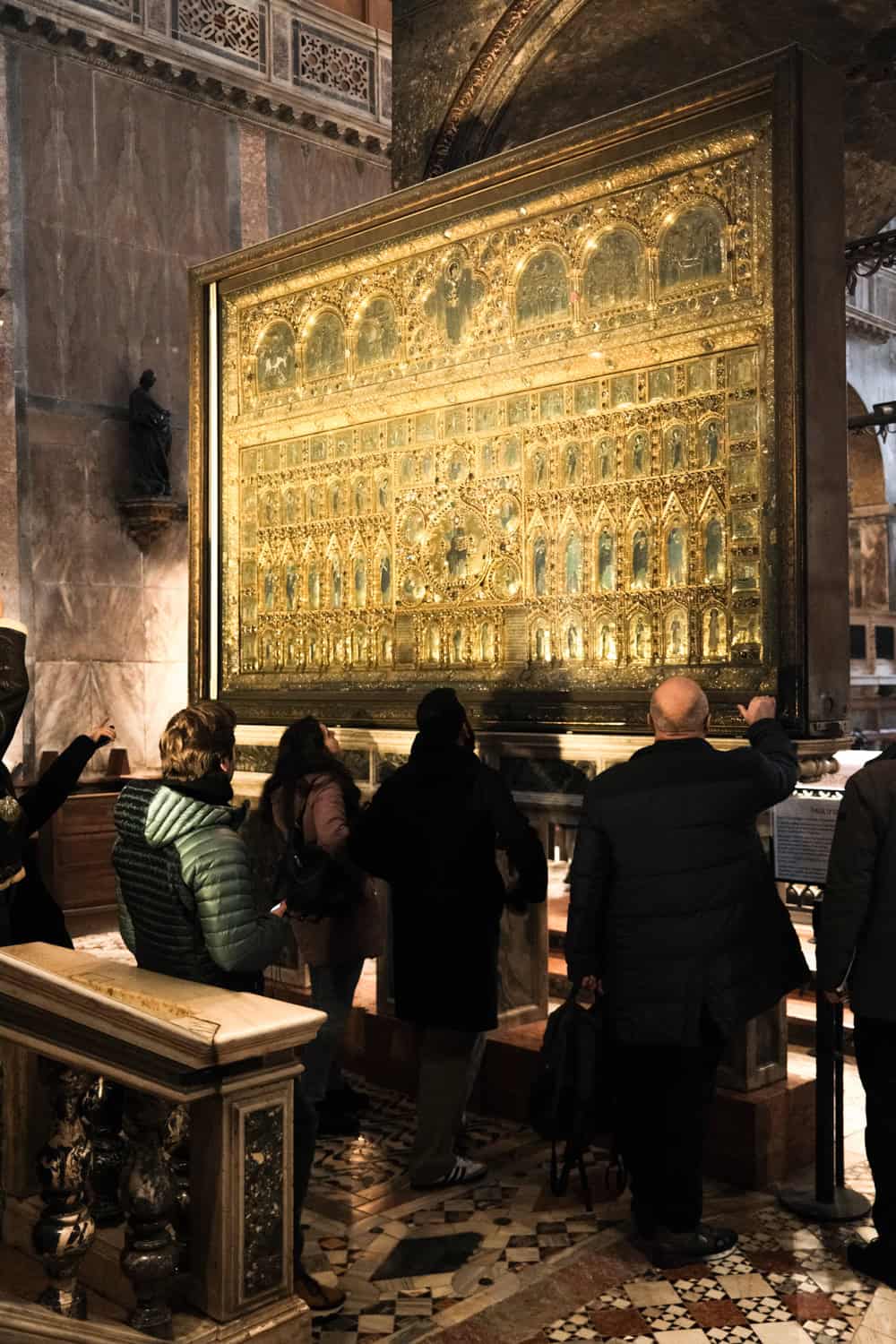Close-up of the Pala d’Oro, the ornate gold altarpiece inside St. Mark’s Basilica, encrusted with precious gems and intricate religious detail.